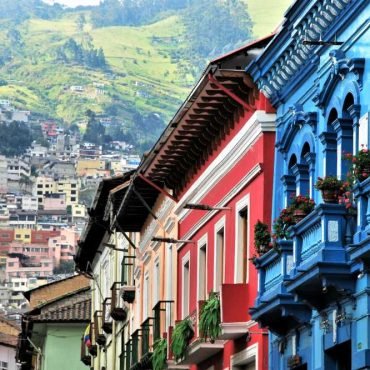 View of beautiful and colorful colonial architecture in Quito, Ecuador with mountains in the background