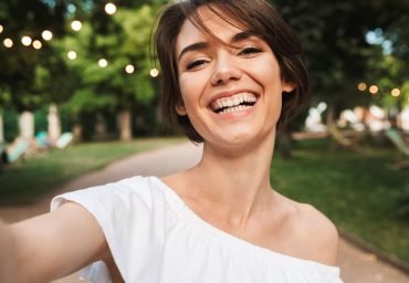 smiling-young-girl-taking-a-selfie-NR2ZWMP.jpg